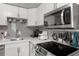 Bright kitchen featuring modern appliances, light countertops, and stylish backsplash at 5651 Kelly N Dr, St Petersburg, FL 33703