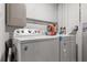 Laundry room with white washer, dryer and water heater at 5651 Kelly N Dr, St Petersburg, FL 33703