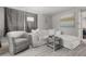 Inviting living room boasts a plush white sectional, gray armchair, and stylish decor at 5651 Kelly N Dr, St Petersburg, FL 33703
