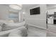 Open-concept view into living room with wall-mounted TV and into the kitchen with modern appliances at 5651 Kelly N Dr, St Petersburg, FL 33703