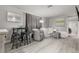 Comfortable living room with lots of seating, wood floors, and ample natural light at 5651 Kelly N Dr, St Petersburg, FL 33703