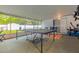 Enclosed patio with ping pong table, storage and ceiling, offering a relaxing and recreational space at 5651 Kelly N Dr, St Petersburg, FL 33703