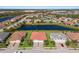 Aerial view of a residential community featuring houses around a lake under a partly cloudy sky at 2532 Avolet Ct, Lakewood Ranch, FL 34211