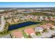 Aerial view of a community with houses surrounding a lake at 2532 Avolet Ct, Lakewood Ranch, FL 34211