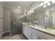 Modern bathroom features dual sinks, granite countertops, and glass-enclosed walk-in shower at 2532 Avolet Ct, Lakewood Ranch, FL 34211