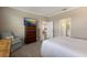 Cozy bedroom with TV, chair, and en-suite bathroom access creating a relaxing retreat at 2532 Avolet Ct, Lakewood Ranch, FL 34211