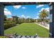 Beautiful community area featuring lush green grass, shady pergola, and inviting seating at 2532 Avolet Ct, Lakewood Ranch, FL 34211
