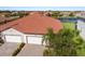 Aerial view of home featuring a tile roof, 3-car garage, and landscaped yard in a residential community at 2532 Avolet Ct, Lakewood Ranch, FL 34211