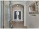 View of a foyer featuring tile floors, a mirror, and double glass doors at 2532 Avolet Ct, Lakewood Ranch, FL 34211