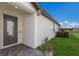 Exterior showcasing the front door, landscaping, and well-maintained lawn at 2532 Avolet Ct, Lakewood Ranch, FL 34211