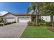 Charming home featuring a three car garage, paver driveway, manicured lawn and mature landscaping at 2532 Avolet Ct, Lakewood Ranch, FL 34211