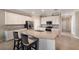 Bright kitchen features white cabinets, stainless steel appliances, and a large island with bar seating at 2532 Avolet Ct, Lakewood Ranch, FL 34211