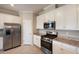 This kitchen has stainless steel appliances, granite countertops and white cabinets at 2532 Avolet Ct, Lakewood Ranch, FL 34211