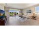 Bright living room with a comfortable sofa and large sliding glass doors leading to a screened porch at 2532 Avolet Ct, Lakewood Ranch, FL 34211