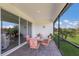 Screened patio with brick flooring, sliding glass doors, and a table with four chairs at 2532 Avolet Ct, Lakewood Ranch, FL 34211