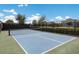 View of a well-maintained tennis court featuring a blue playing surface and a surrounding fence at 2532 Avolet Ct, Lakewood Ranch, FL 34211