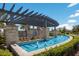 Scenic water feature with fountains, a pergola, lush greenery, and comfortable seating areas for relaxation at 2532 Avolet Ct, Lakewood Ranch, FL 34211