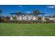 Stunning water feature with fountains, lush greenery, seating areas, and beautiful blue water on a sunny day at 2532 Avolet Ct, Lakewood Ranch, FL 34211
