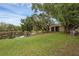 Lush backyard with mature trees, pond, and screened-in patio for outdoor enjoyment at 146 51St Street E Cir, Palmetto, FL 34221