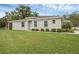 Exterior view of house with well-maintained lawn and foundation planting at 146 51St Street E Cir, Palmetto, FL 34221