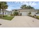Street view of the home featuring a two-car garage, driveway and green landscaping at 146 51St Street E Cir, Palmetto, FL 34221