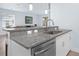 Kitchen featuring granite countertops, stainless steel appliances and fixtures, and a view of the dining area at 146 51St Street E Cir, Palmetto, FL 34221