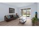 Cozy living room with a view of the screened-in patio, perfect for relaxation at 146 51St Street E Cir, Palmetto, FL 34221