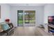 Bright living room with sliding glass doors leading to a screened patio and beautiful backyard view at 146 51St Street E Cir, Palmetto, FL 34221