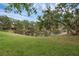 Picturesque pond surrounded by lush greenery, offering a serene and private backyard at 146 51St Street E Cir, Palmetto, FL 34221