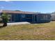 Spacious backyard with a patio, privacy fence, and a lush green lawn at 3347 Roxbury Dr, Holiday, FL 34691