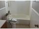 Classic bathroom featuring tile accents, a shower-tub combination, and modern fixtures at 3347 Roxbury Dr, Holiday, FL 34691