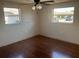 Bedroom featuring hardwood floors, natural light, and a ceiling fan at 3347 Roxbury Dr, Holiday, FL 34691