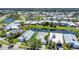 An aerial view showcases pond-front homes surrounded by lush landscaping and serene water features at 530 Bimini Bay Blvd, Apollo Beach, FL 33572
