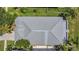 Aerial shot showcasing the home's metal roof, adjacent wooden decks, and verdant surroundings at 530 Bimini Bay Blvd, Apollo Beach, FL 33572