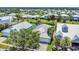 Aerial view of pond front houses with lush green landscaping and tropical palm trees at 530 Bimini Bay Blvd, Apollo Beach, FL 33572