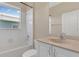 Bathroom featuring a tub and shower combination with white tile and a marble vanity sink at 530 Bimini Bay Blvd, Apollo Beach, FL 33572