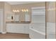 Bathroom featuring a dual vanity, granite countertop, and a modern soaking tub at 530 Bimini Bay Blvd, Apollo Beach, FL 33572