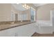 Bathroom boasts a dual vanity, granite countertop, and a relaxing soaking tub at 530 Bimini Bay Blvd, Apollo Beach, FL 33572