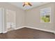 Bedroom has an adjacent bathroom, laminate floors, and a window view of lush greenery at 530 Bimini Bay Blvd, Apollo Beach, FL 33572