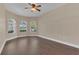 Bedroom with a bay window, ceiling fan, and dark laminate flooring at 530 Bimini Bay Blvd, Apollo Beach, FL 33572