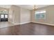 Dining room featuring dark wood-look floors and neutral paint, situated near the front entrance at 530 Bimini Bay Blvd, Apollo Beach, FL 33572