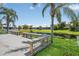 Outdoor dock with attached benches overlooking a serene waterfront view and clear blue skies at 530 Bimini Bay Blvd, Apollo Beach, FL 33572