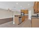 Open kitchen featuring wood cabinets, granite counters, stainless appliances, and breakfast bar at 530 Bimini Bay Blvd, Apollo Beach, FL 33572