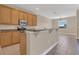 Kitchen with wood cabinets, breakfast bar, granite counters, and stainless steel appliances at 530 Bimini Bay Blvd, Apollo Beach, FL 33572