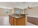 Kitchen with wood cabinets, granite counters, a breakfast bar, and tile floors at 530 Bimini Bay Blvd, Apollo Beach, FL 33572
