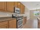 Well-lit kitchen with stainless steel appliances, wood cabinetry, and granite countertops at 530 Bimini Bay Blvd, Apollo Beach, FL 33572