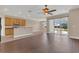 Open kitchen with wood cabinets, granite countertops, stainless steel appliances, and breakfast bar at 530 Bimini Bay Blvd, Apollo Beach, FL 33572