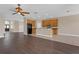 Open-concept kitchen features wood cabinets, dark laminate floor, and an eat-in island at 530 Bimini Bay Blvd, Apollo Beach, FL 33572