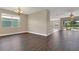 Open-concept living area with wood-look flooring, neutral walls, and sliding doors to the lanai at 530 Bimini Bay Blvd, Apollo Beach, FL 33572