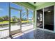 A view of the canal from the tiled, screened in patio with sliding glass doors leading to an interior room at 530 Bimini Bay Blvd, Apollo Beach, FL 33572